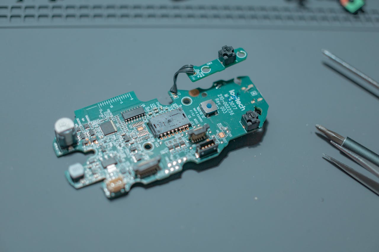 Detailed view of a circuit board with electronic components and tools.